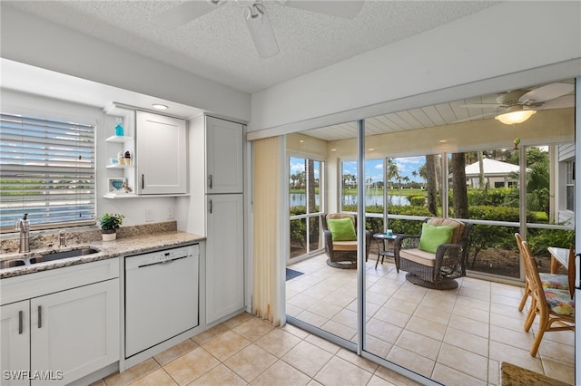 14987 Rivers Edge Ct Unit 139, Fort Myers, FL 33908 - kitchen with dishwasher, ceiling fan, a sink, a water view, and a textured ceiling