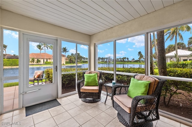 sunroom with a water view and wooden ceiling