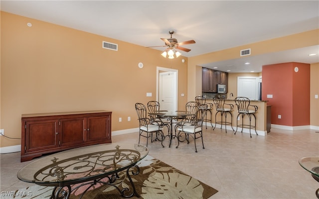 dining room with ceiling fan and light tile patterned flooring