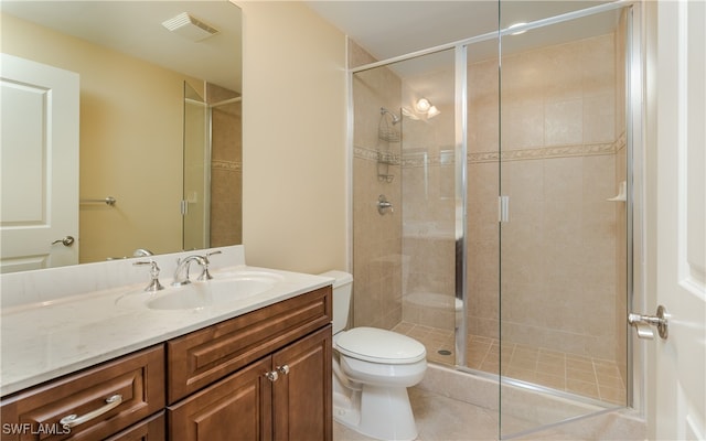 bathroom with tile patterned flooring, walk in shower, vanity, and toilet