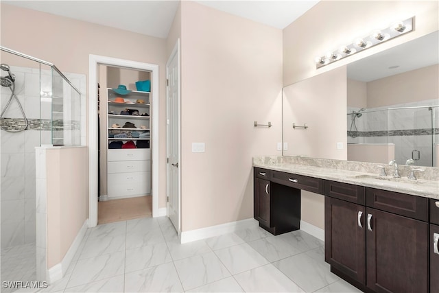 bathroom with walk in shower and vanity