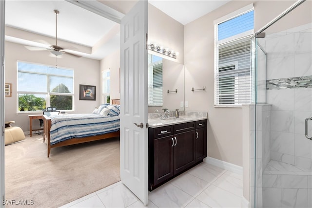 bathroom featuring ceiling fan, a shower with door, and vanity