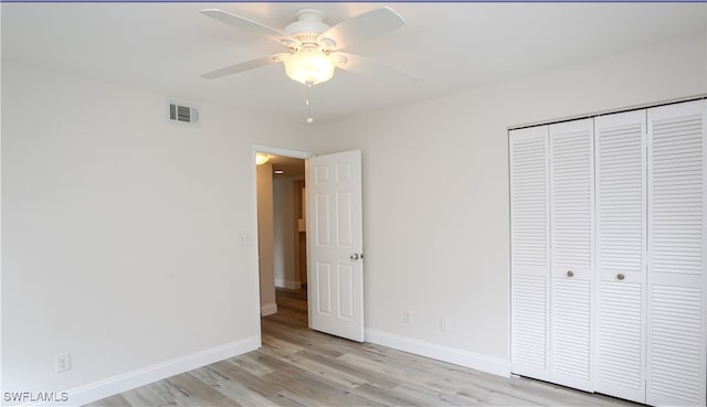 unfurnished bedroom with ceiling fan, a closet, and light hardwood / wood-style floors