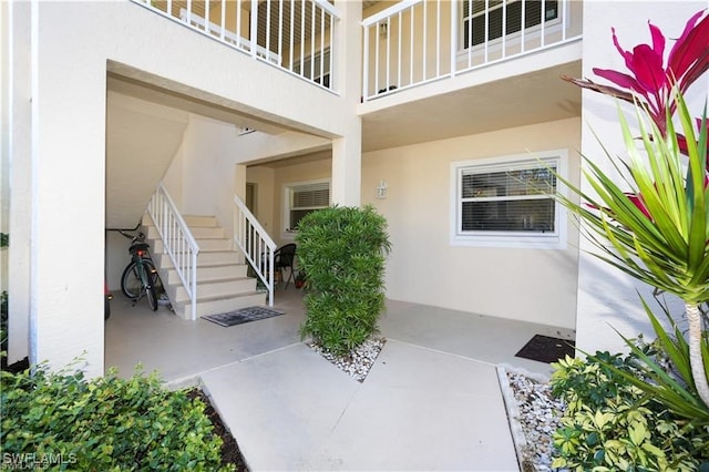 entrance to property featuring a balcony and a patio area