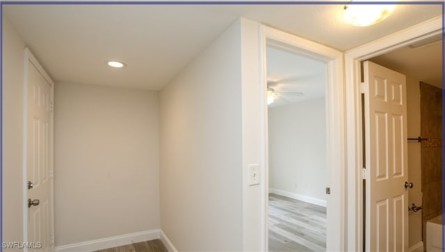 corridor with light wood-type flooring