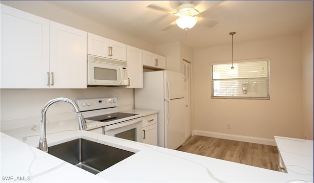 kitchen featuring light wood-type flooring, white appliances, white cabinetry, and sink