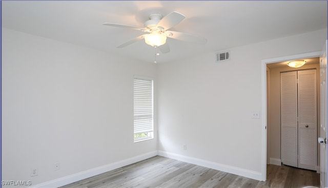 empty room featuring ceiling fan and light hardwood / wood-style floors