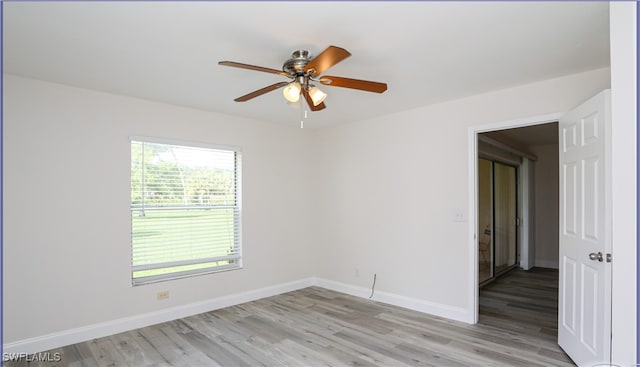 spare room with ceiling fan and light wood-type flooring