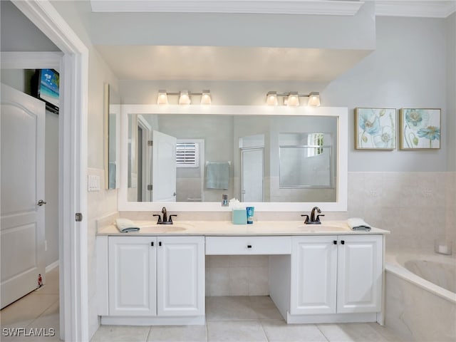 bathroom with a tub to relax in, vanity, and tile patterned floors