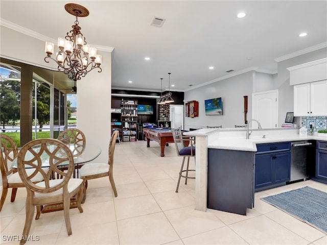 kitchen featuring a kitchen breakfast bar, blue cabinetry, crown molding, a notable chandelier, and pendant lighting