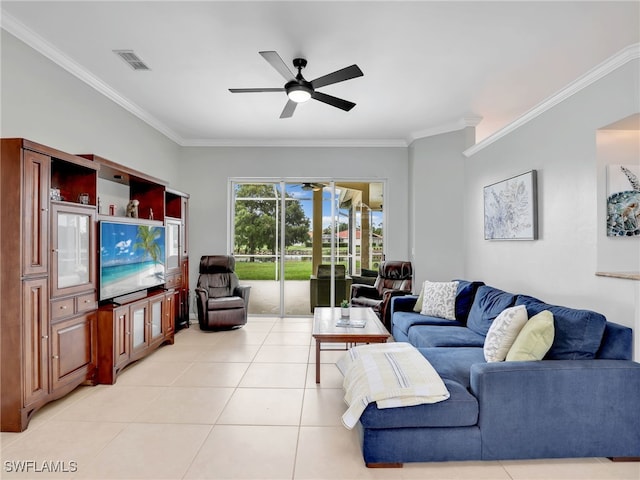 tiled living room with ceiling fan and crown molding