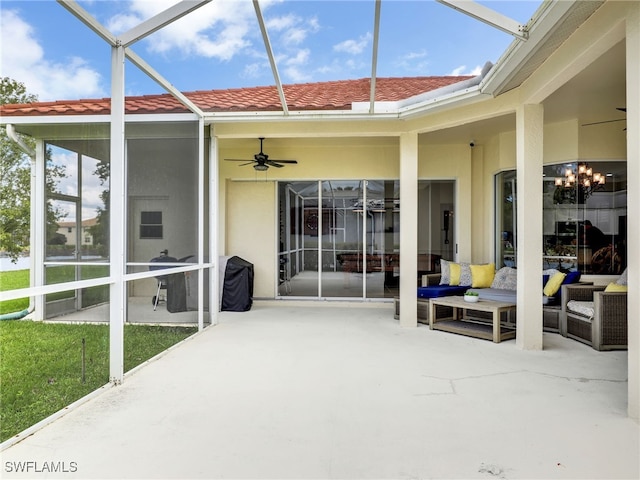 view of patio featuring glass enclosure and ceiling fan