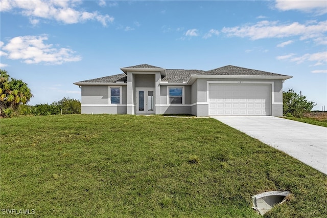 prairie-style house featuring stucco siding, concrete driveway, a garage, and a front lawn
