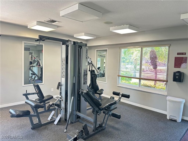 workout area featuring a textured ceiling