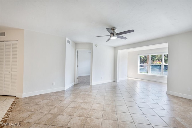 tiled empty room with ceiling fan