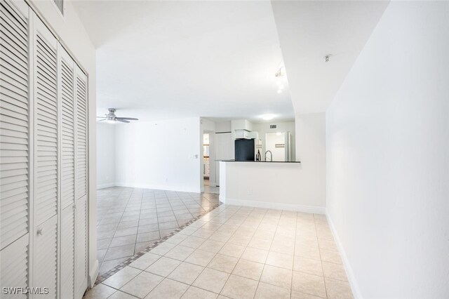 interior space featuring sink, ceiling fan, and light tile patterned flooring