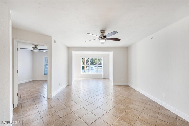 unfurnished room featuring ceiling fan and light tile patterned floors