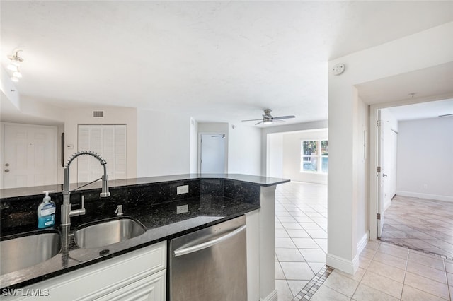 kitchen featuring sink, stainless steel dishwasher, ceiling fan, light tile patterned floors, and white cabinetry