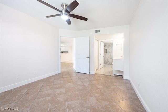 unfurnished bedroom with ensuite bathroom and ceiling fan