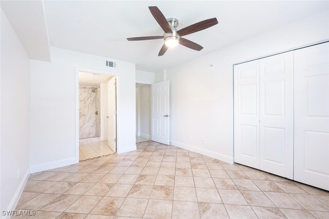 unfurnished bedroom with ceiling fan and a closet