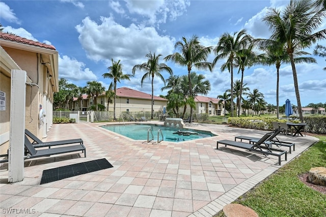 view of swimming pool featuring a jacuzzi and a patio