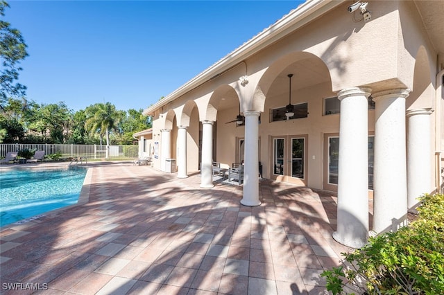 view of swimming pool featuring ceiling fan and a patio area