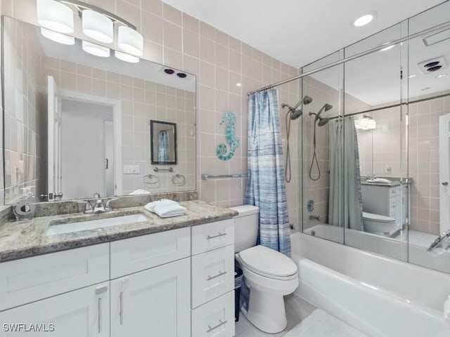 1258 Jamaica Rd, Marco Island, FL 34145 - full bathroom featuring tile walls, shower / bath combo, vanity, and toilet