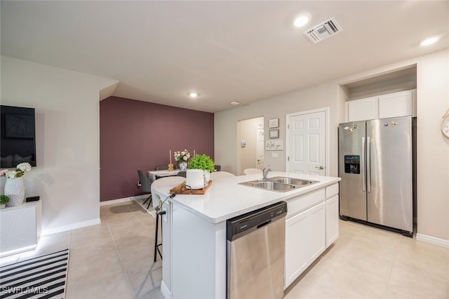 kitchen featuring a center island with sink, stainless steel appliances, sink, and white cabinetry