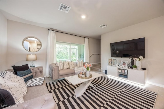 living room featuring baseboards and visible vents