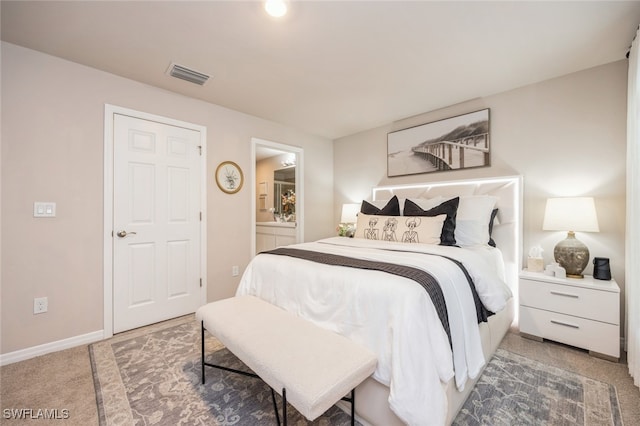 carpeted bedroom featuring connected bathroom