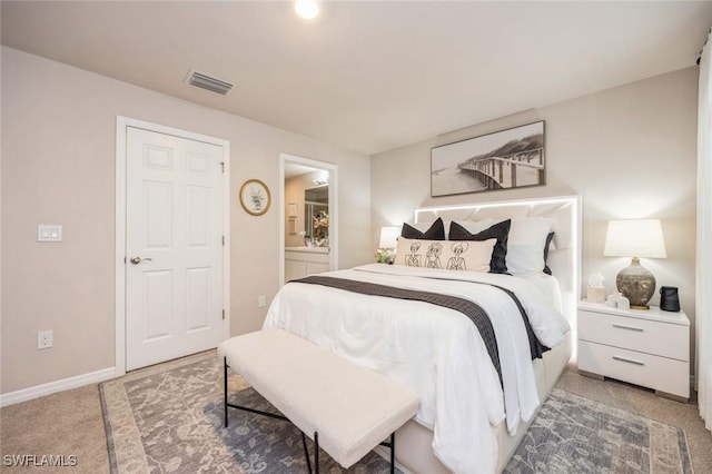 bedroom featuring ensuite bath, visible vents, baseboards, and light carpet