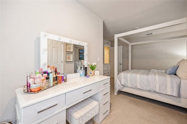 bedroom featuring visible vents and light carpet
