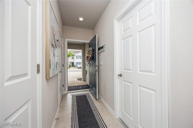 hall with light tile patterned floors