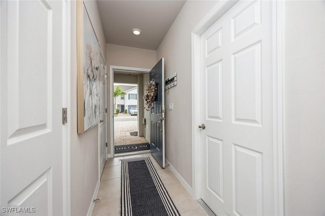 entryway featuring light tile patterned floors and baseboards