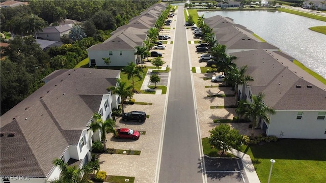 drone / aerial view with a water view and a residential view