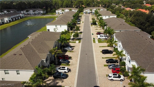 birds eye view of property featuring a water view and a residential view