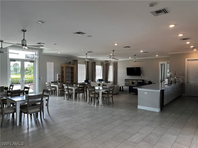 dining area featuring ceiling fan, french doors, and ornamental molding