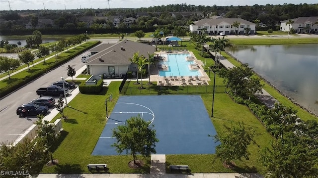 view of basketball court featuring a water view, a yard, and a community pool