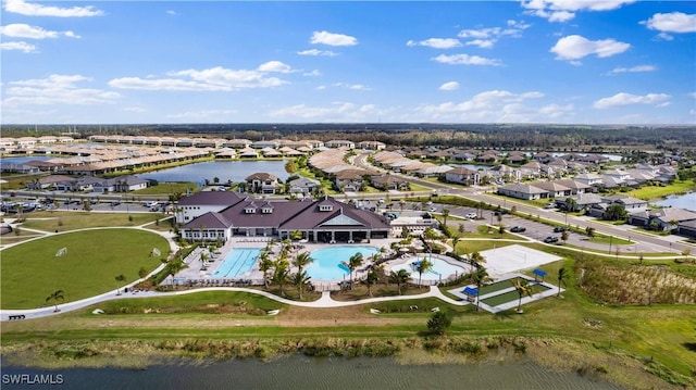 drone / aerial view featuring a residential view and a water view