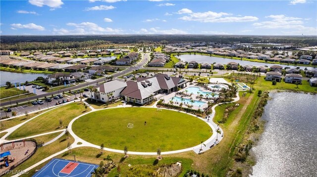 drone / aerial view with a residential view and a water view