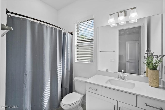 bathroom featuring toilet, curtained shower, and vanity