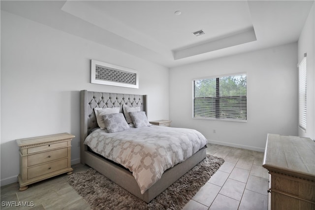 bedroom featuring a raised ceiling