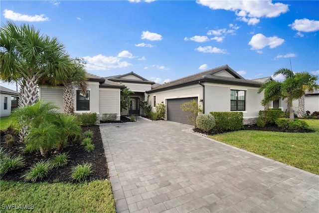 view of front of home featuring a front yard and a garage