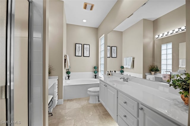 bathroom featuring a tub to relax in, tile patterned flooring, vanity, and toilet