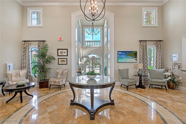 foyer entrance featuring a chandelier and ornamental molding