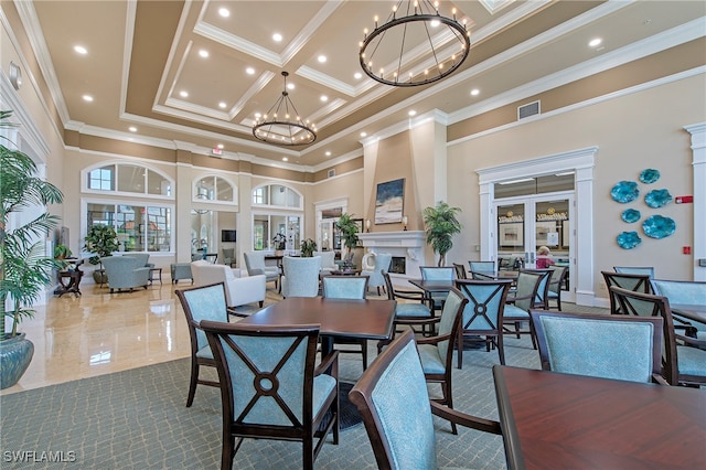 dining area with a towering ceiling, ornamental molding, and an inviting chandelier