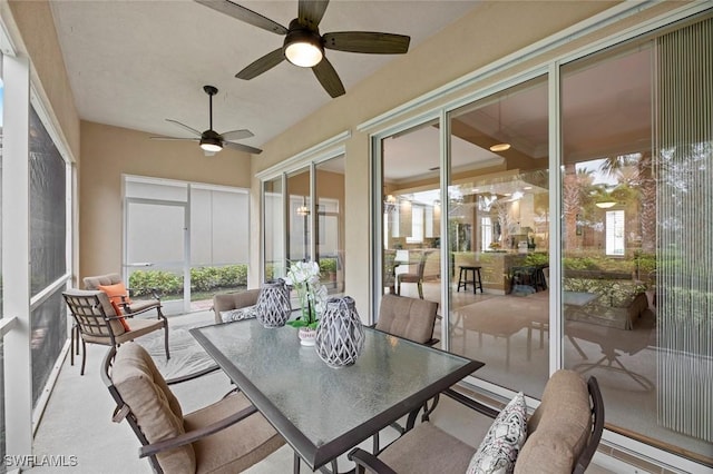 sunroom featuring ceiling fan