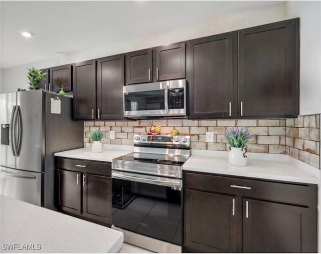 kitchen with dark brown cabinets, decorative backsplash, and appliances with stainless steel finishes