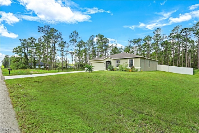 ranch-style home with a front yard and a garage