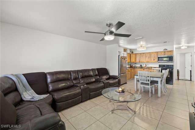 tiled living room with ceiling fan and a textured ceiling